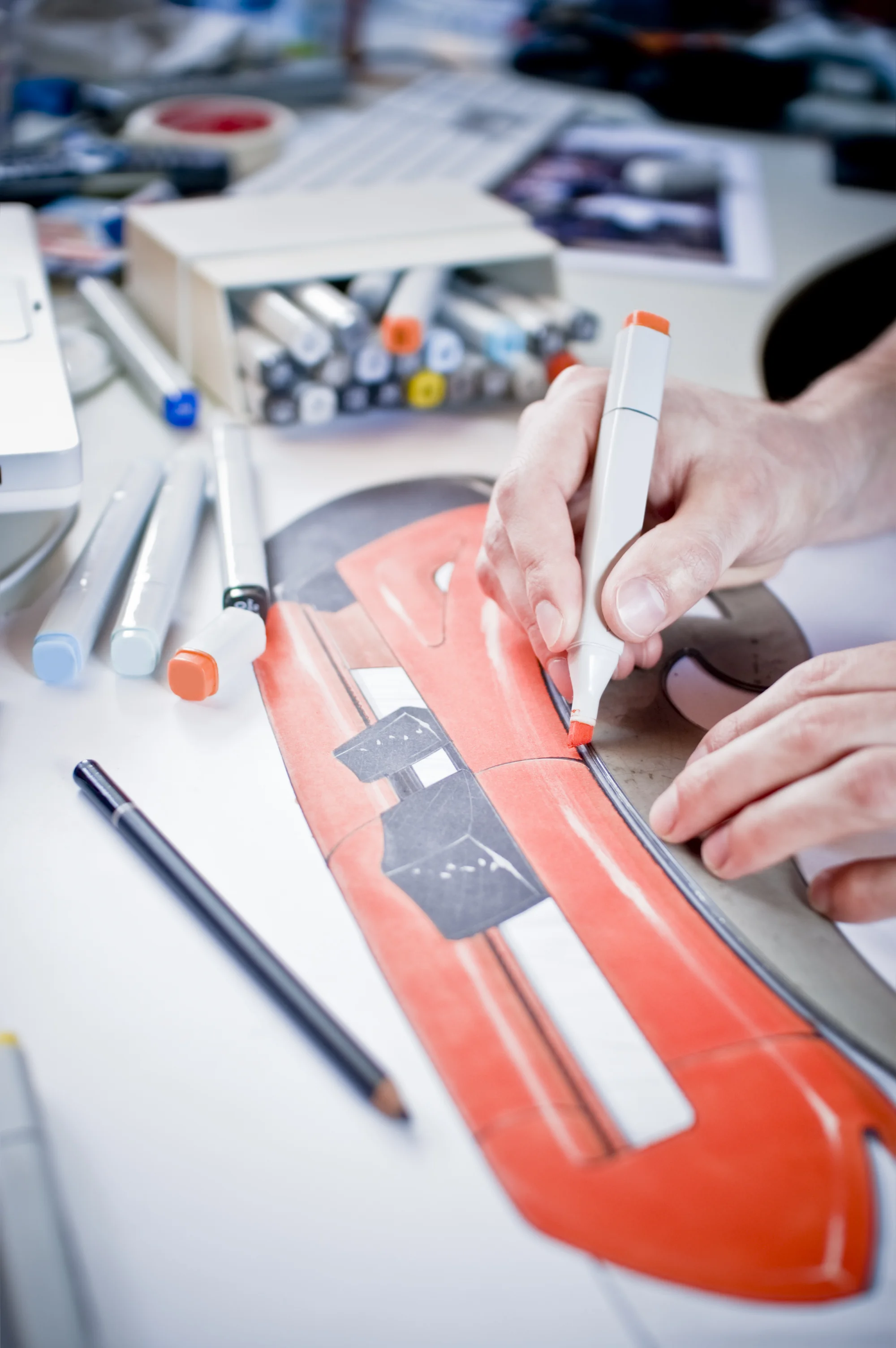 Industrial designer hand-rendering a product concept with markers during early development