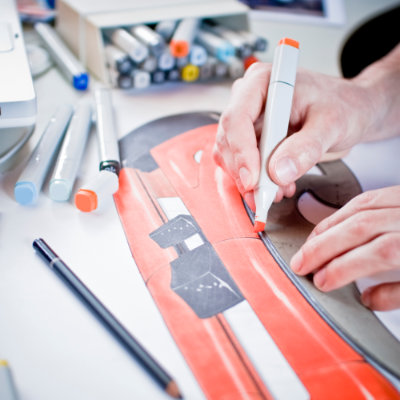 Industrial designer hand-rendering a product concept with markers