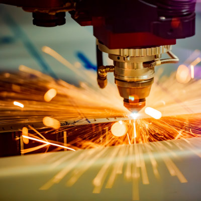 Laser cutting a metal component — one of many manufacturing processes considered during DFM