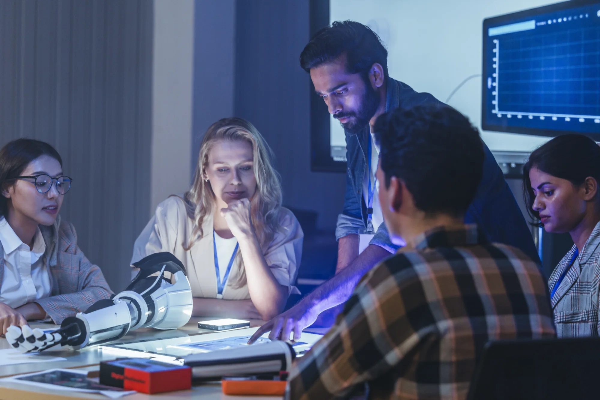 Engineering team collaborating on product design during a design review meeting